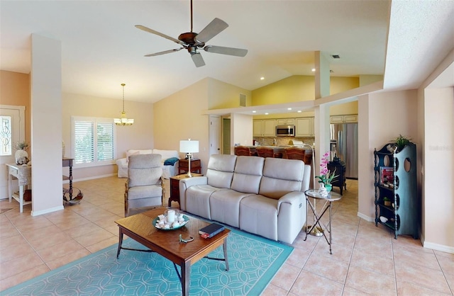 tiled living room featuring ceiling fan with notable chandelier and vaulted ceiling