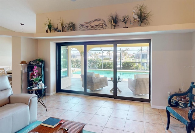 doorway featuring light tile patterned floors and a towering ceiling