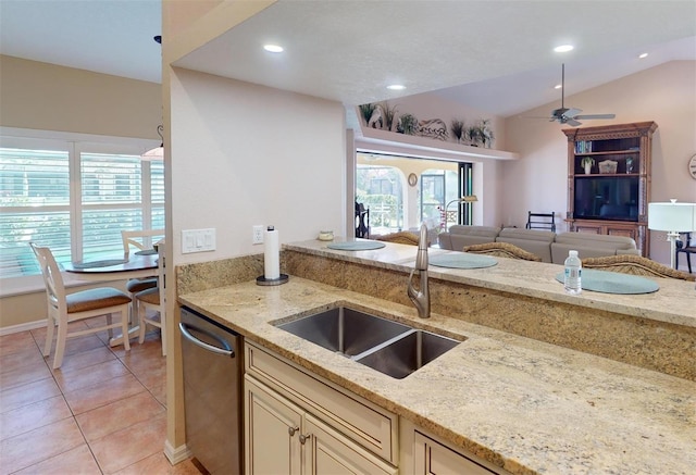 kitchen featuring stainless steel dishwasher, lofted ceiling, light stone countertops, and sink