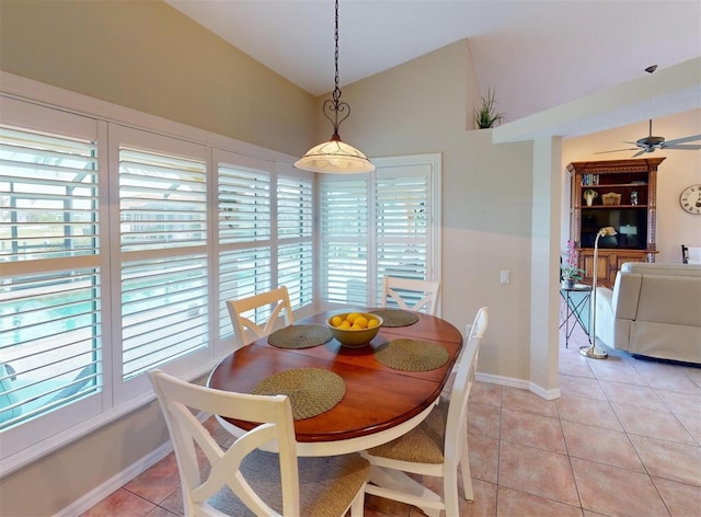 tiled dining room featuring ceiling fan and lofted ceiling