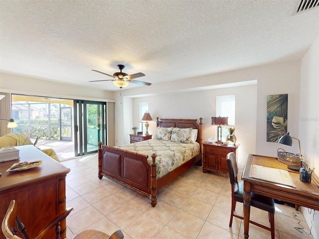 tiled bedroom featuring ceiling fan, access to exterior, and a textured ceiling