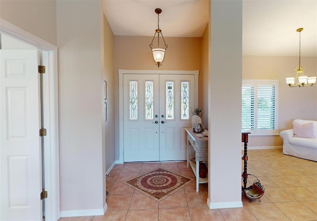 foyer featuring a notable chandelier and light tile patterned flooring