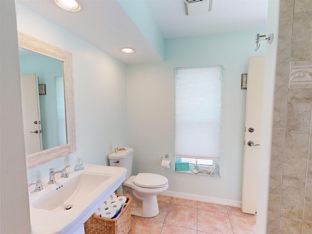 bathroom with tile patterned floors, toilet, and sink