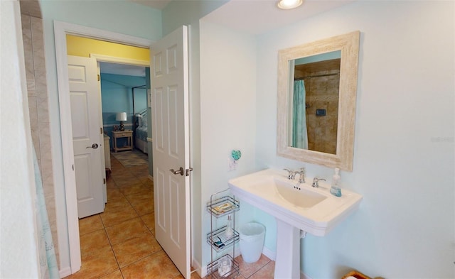 bathroom with tile patterned floors and curtained shower