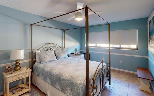 tiled bedroom featuring ceiling fan