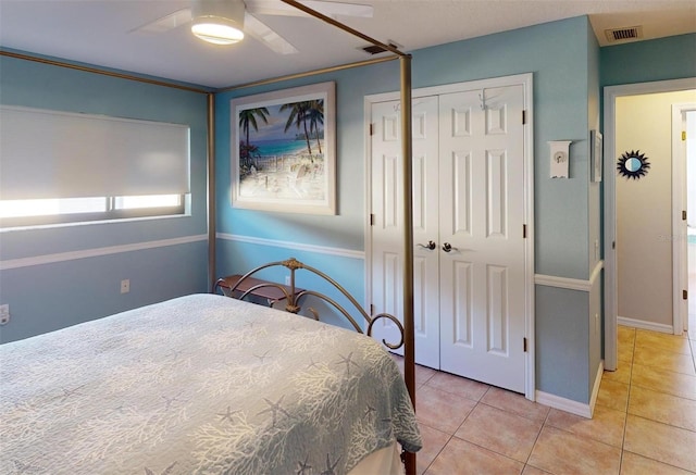 tiled bedroom with ceiling fan