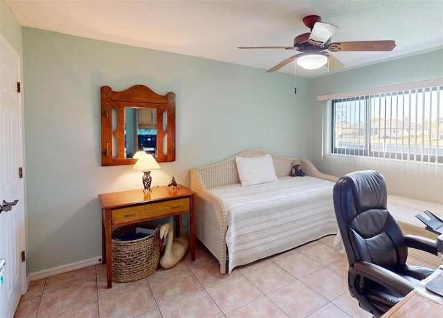 bedroom with ceiling fan and light tile patterned floors