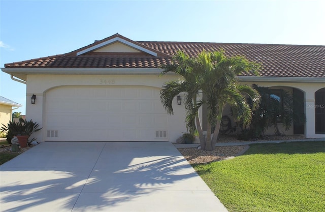 mediterranean / spanish-style house featuring a garage and a front lawn