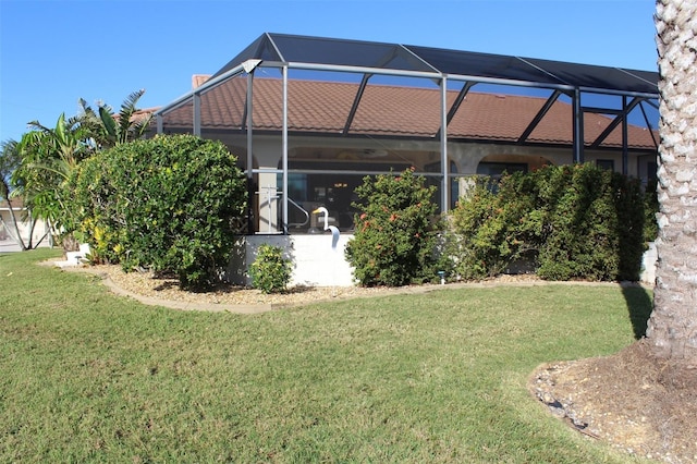 view of yard with glass enclosure