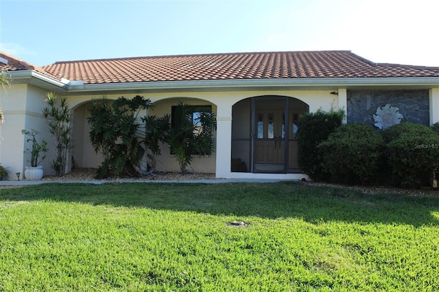 back of property featuring a lawn