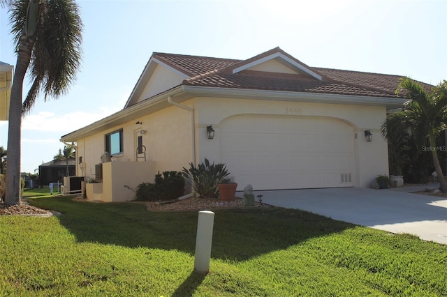 view of side of property featuring a lawn and a garage