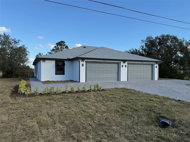 view of front of home with a front yard and a garage