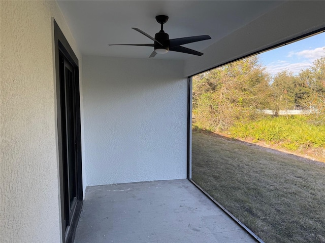 unfurnished sunroom featuring ceiling fan