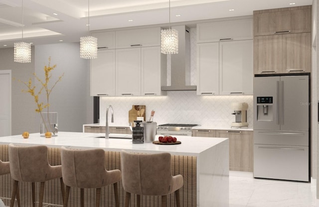 kitchen featuring white appliances, hanging light fixtures, and an island with sink