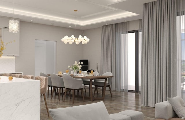 dining area with hardwood / wood-style floors, an inviting chandelier, a raised ceiling, and a wealth of natural light