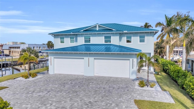 view of front of home with a water view and a garage