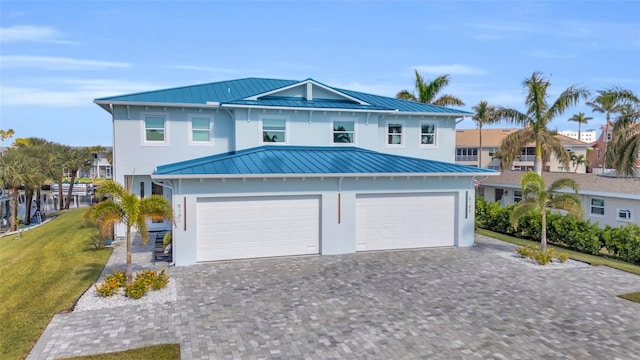 view of front of house featuring a garage and a front lawn