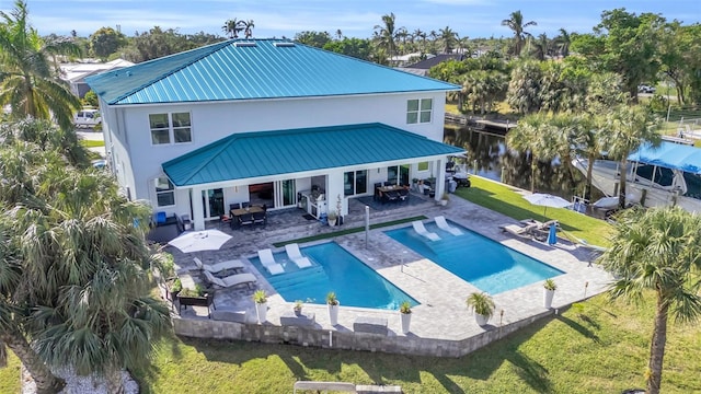 back of property with an outdoor living space, a yard, and a patio