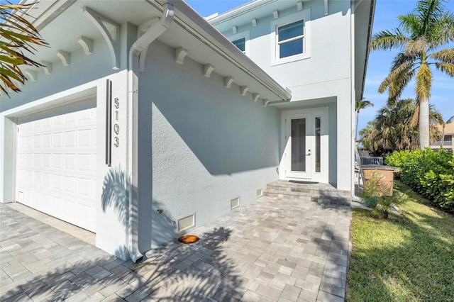 exterior space featuring french doors and a garage