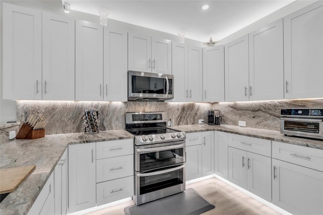 kitchen with white cabinetry and appliances with stainless steel finishes