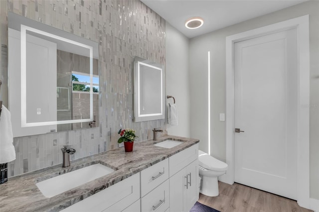 bathroom with vanity, wood-type flooring, and toilet