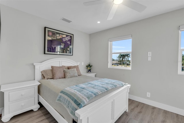 bedroom with ceiling fan and light hardwood / wood-style floors