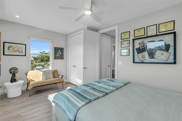 bedroom with light wood-type flooring, a closet, and ceiling fan