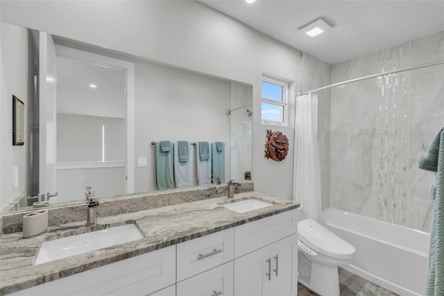 full bathroom with shower / bath combo with shower curtain, vanity, hardwood / wood-style floors, and toilet