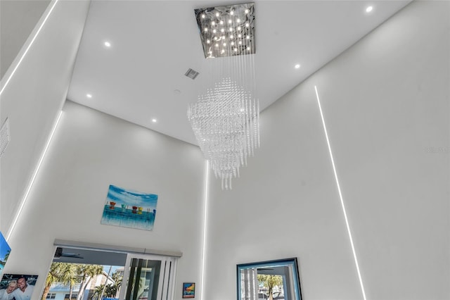 room details with ceiling fan with notable chandelier