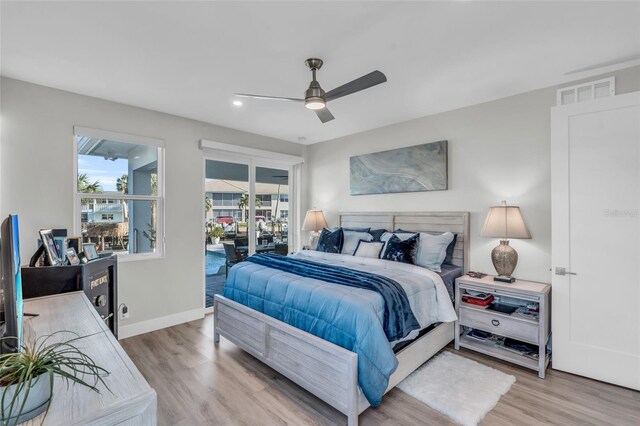 bedroom with access to exterior, hardwood / wood-style flooring, and ceiling fan