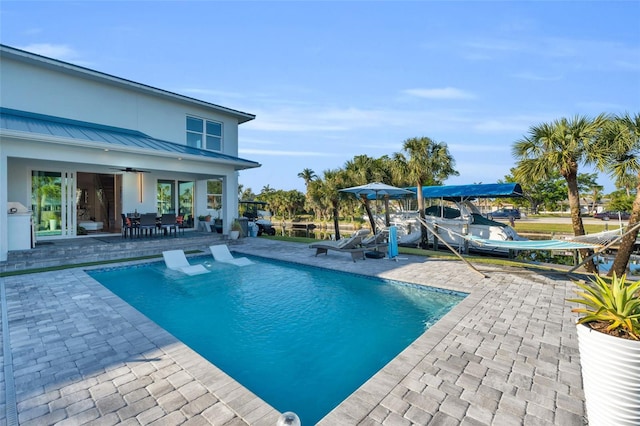 view of pool with a patio and ceiling fan