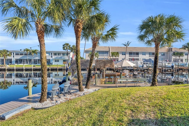 dock area featuring a lawn and a water view