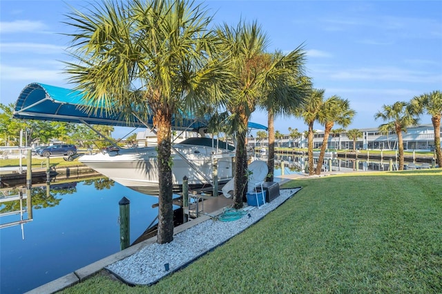 dock area with a lawn and a water view