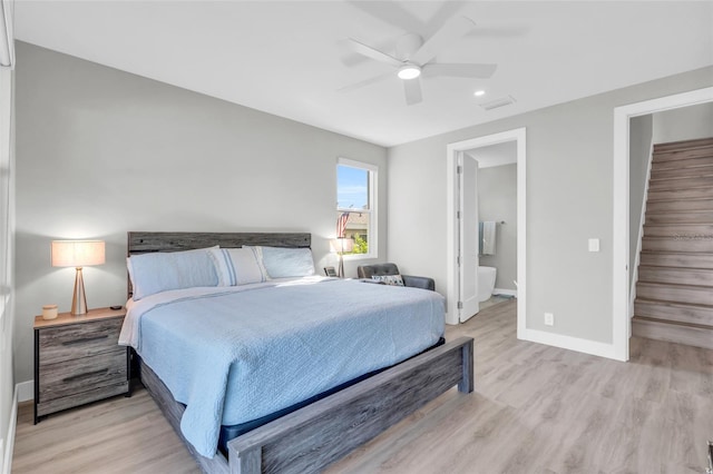 bedroom featuring ensuite bathroom, light hardwood / wood-style flooring, and ceiling fan