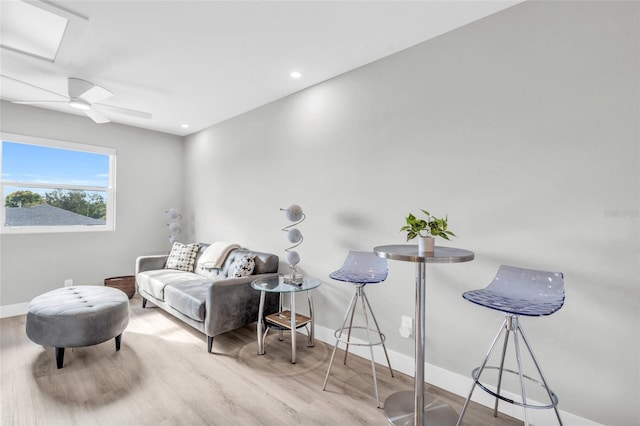 living room featuring ceiling fan and light hardwood / wood-style flooring