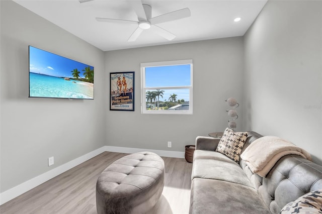 living room with ceiling fan and light wood-type flooring