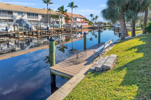 dock area featuring a lawn and a water view