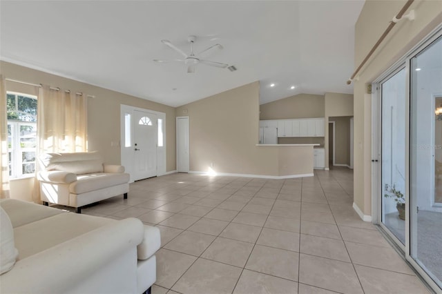 living room with ceiling fan, light tile patterned floors, and vaulted ceiling