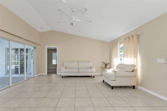 tiled living room featuring ceiling fan and lofted ceiling