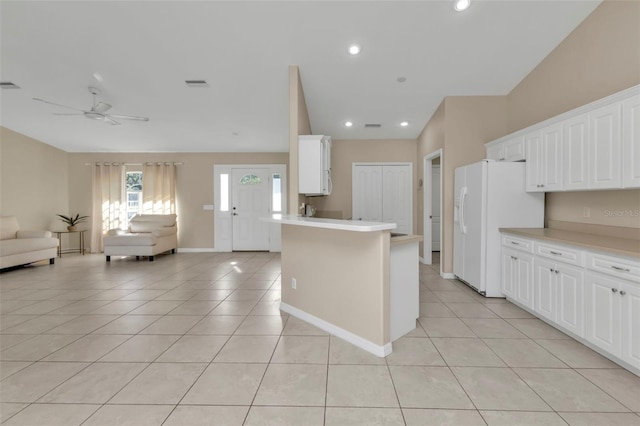 kitchen with vaulted ceiling, ceiling fan, light tile patterned floors, white cabinets, and white fridge with ice dispenser