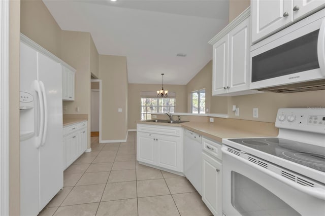 kitchen featuring white appliances, vaulted ceiling, sink, a notable chandelier, and white cabinets