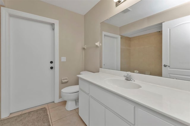 bathroom with tile patterned flooring, vanity, and toilet