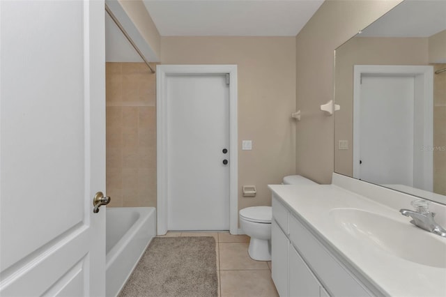 full bathroom with tile patterned flooring, vanity, tiled shower / bath combo, and toilet