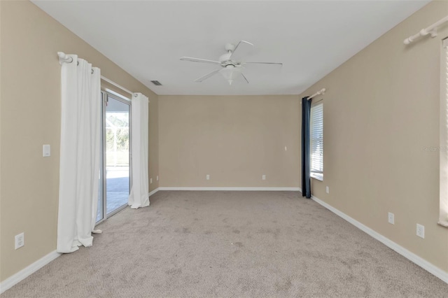 unfurnished room featuring light carpet and ceiling fan