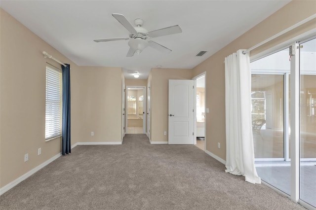 unfurnished bedroom with light carpet, connected bathroom, and ceiling fan