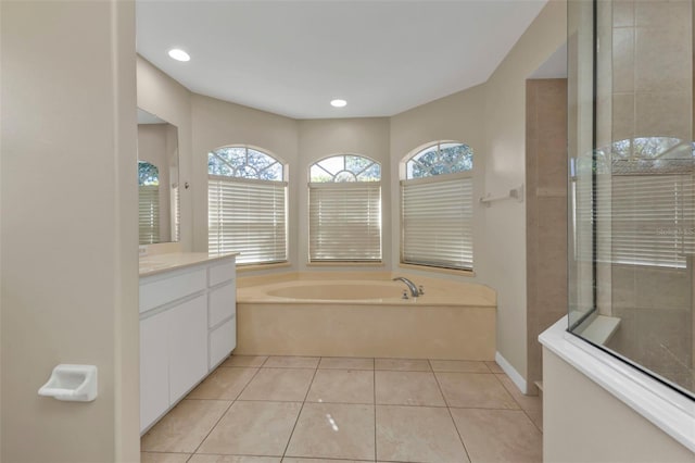 bathroom with plus walk in shower, vanity, and tile patterned floors