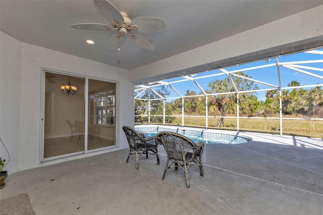 view of patio with ceiling fan and a lanai