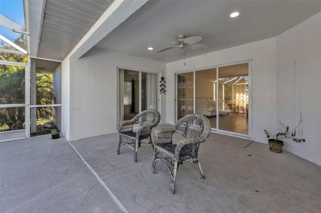 view of patio featuring ceiling fan and a lanai