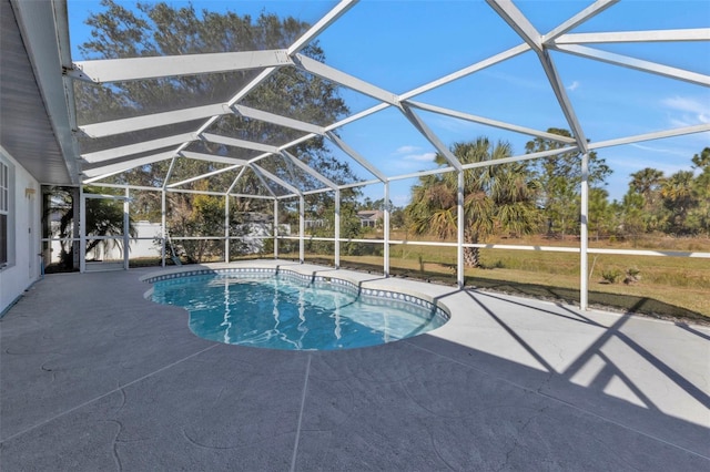 view of swimming pool featuring a patio area and a lanai