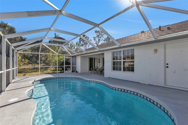 view of swimming pool featuring a lanai and a patio